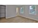 Neutral bedroom with light hardwood floors, closet and ensuite bathroom access at 3616 W Platt St, Tampa, FL 33609