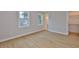 Bright bedroom with hardwood floors, two windows and a walk-in closet at 3616 W Platt St, Tampa, FL 33609