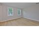 Bright bedroom featuring hardwood floors and two windows providing natural light at 3616 W Platt St, Tampa, FL 33609