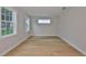 Bright bedroom with a hardwood floor and large windows with trim overlooking the front yard at 3616 W Platt St, Tampa, FL 33609