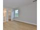 Bedroom featuring a closet, hardwood floors, and a large window at 3616 W Platt St, Tampa, FL 33609
