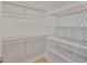 Walk in closet with several rows of light wooden shelving at 3616 W Platt St, Tampa, FL 33609