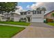 Charming two-story home boasts a well-manicured lawn, dark shutters, and an attached two-car garage at 3616 W Platt St, Tampa, FL 33609