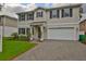 Charming two-story home featuring a two-car garage, manicured lawn, and a welcoming front porch at 3616 W Platt St, Tampa, FL 33609