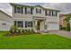 Charming two-story home boasts a well-manicured lawn, dark shutters, and an attached two-car garage at 3616 W Platt St, Tampa, FL 33609