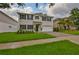Charming two-story home boasts a well-manicured lawn, dark shutters, and an attached two-car garage at 3616 W Platt St, Tampa, FL 33609