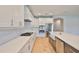 Sleek kitchen equipped with stainless steel appliances, a cooktop, and quartz countertops at 3616 W Platt St, Tampa, FL 33609