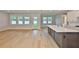 Open-concept kitchen and living room with hardwood floors and an island with a farmhouse sink at 3616 W Platt St, Tampa, FL 33609