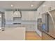 Modern kitchen with white countertops, stainless appliances, and ample cabinet space at 3616 W Platt St, Tampa, FL 33609