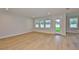 Open-concept living room with hardwood floors, recessed lighting, and large windows overlooking backyard at 3616 W Platt St, Tampa, FL 33609