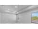 Bright bedroom with tray ceiling, neutral walls, and two windows allowing plenty of natural light at 406 N Westland St # 1, Tampa, FL 33609