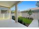 Covered patio offers a view of the landscaped backyard with a small lawn at 406 N Westland St # 1, Tampa, FL 33609