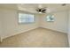 Bright bedroom with tiled floors and natural light from two windows at 4322 Baden Dr, Holiday, FL 34691