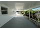 Large covered patio leading to a white storage shed at 4322 Baden Dr, Holiday, FL 34691