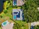 Aerial view of a home with solar panels and a screened-in pool at 4690 Wrentham Pl, Palm Harbor, FL 34685