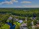 Aerial view highlighting the property within the neighborhood next to a pond at 4690 Wrentham Pl, Palm Harbor, FL 34685