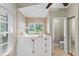 Bright bathroom featuring a walk-in tub with tile surround and natural light at 4690 Wrentham Pl, Palm Harbor, FL 34685