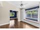 Bedroom with built-in window seat, hardwood floors, and neutral walls at 4690 Wrentham Pl, Palm Harbor, FL 34685