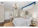Bright bedroom with hardwood floors, a chandelier, and neutral decor at 4690 Wrentham Pl, Palm Harbor, FL 34685