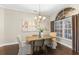 Well-lit dining room with a large window and an elegant chandelier at 4690 Wrentham Pl, Palm Harbor, FL 34685