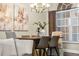 Elegant dining room featuring a modern chandelier, window, and neutral decor with connecting Living Room at 4690 Wrentham Pl, Palm Harbor, FL 34685