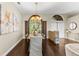 Elegant dining room bathed in natural light from large windows and a stylish chandelier at 4690 Wrentham Pl, Palm Harbor, FL 34685