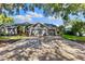Spacious driveway leading to a well-maintained home with a three-car garage at 4690 Wrentham Pl, Palm Harbor, FL 34685