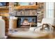 Close up of brick fireplace with fire burning and wood mantle at 4690 Wrentham Pl, Palm Harbor, FL 34685