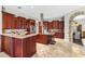 Gourmet kitchen featuring custom cabinetry, stainless steel appliances, and stone countertops at 4690 Wrentham Pl, Palm Harbor, FL 34685