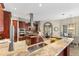 Open kitchen with granite countertops, stainless steel appliances, and ample counter space at 4690 Wrentham Pl, Palm Harbor, FL 34685