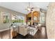 Cozy living room featuring a fireplace, vaulted ceilings and beautiful backyard pool views at 4690 Wrentham Pl, Palm Harbor, FL 34685