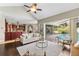 Open floor plan featuring a living room, kitchen, dining area, and sliding doors to screened-in pool at 4690 Wrentham Pl, Palm Harbor, FL 34685