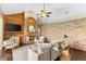 Cozy living room featuring a brick fireplace with a wood mantle and stylish decor at 4690 Wrentham Pl, Palm Harbor, FL 34685