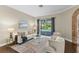 Bright, neutral living room with pool views at 4690 Wrentham Pl, Palm Harbor, FL 34685