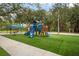 Community playground featuring play structures, picnic tables, and a covered gazebo at 4690 Wrentham Pl, Palm Harbor, FL 34685