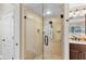 Glass enclosed shower featuring stone-look tile at 4690 Wrentham Pl, Palm Harbor, FL 34685