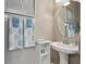 Bathroom with stylish pedestal sink, round mirror, decor, and decorative towels at 4815 Barnstead Dr, Riverview, FL 33578