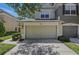 View of a two-story home with an attached two-car garage and well-maintained landscaping at 4815 Barnstead Dr, Riverview, FL 33578