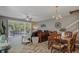 Open-concept living and dining area with wood-look floors and access to an outdoor patio at 4815 Barnstead Dr, Riverview, FL 33578