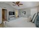 Stylishly furnished main bedroom with ceiling fan, ensuite and television at 4815 Barnstead Dr, Riverview, FL 33578