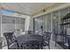 Covered patio features an ornate table and chairs, string lights and sliding glass doors to the interior at 4815 Barnstead Dr, Riverview, FL 33578