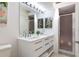 Bathroom features a white double vanity, a framed mirror, and a glass door enclosed shower at 623 Garland Cir, Indian Rocks Beach, FL 33785