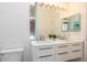 Bright bathroom with a double sink vanity, a large mirror, and neutral wall colors at 623 Garland Cir, Indian Rocks Beach, FL 33785