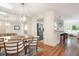 Bright dining area featuring a modern chandelier and wood table with seating for four at 623 Garland Cir, Indian Rocks Beach, FL 33785