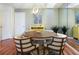 Cozy dining room with a wooden table, chairs, and chandelier lighting at 623 Garland Cir, Indian Rocks Beach, FL 33785