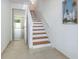 Inviting entryway featuring tile floors, a staircase, and a glimpse into the living space at 623 Garland Cir, Indian Rocks Beach, FL 33785