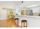 Open kitchen and dining area with breakfast bar, hardwood floors, and neutral decor at 623 Garland Cir, Indian Rocks Beach, FL 33785
