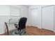 Bright home office space with hard wood floors and a modern glass desk near a sunlit window at 623 Garland Cir, Indian Rocks Beach, FL 33785