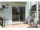 Exterior patio with a grill, stylish seating, and sliding glass door at 623 Garland Cir, Indian Rocks Beach, FL 33785