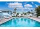 Community swimming pool with lounge chairs and umbrellas at 623 Garland Cir, Indian Rocks Beach, FL 33785